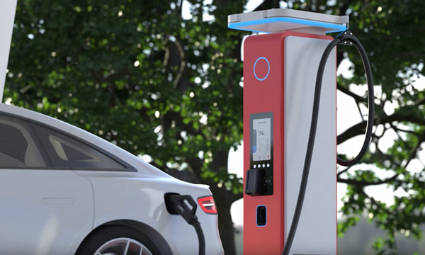 A DC fast charger next to an electric car